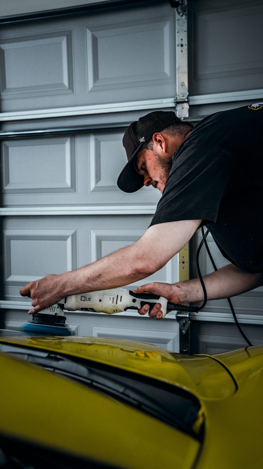 BEX Detailing Lab polishing the paint on a yellow Corvette